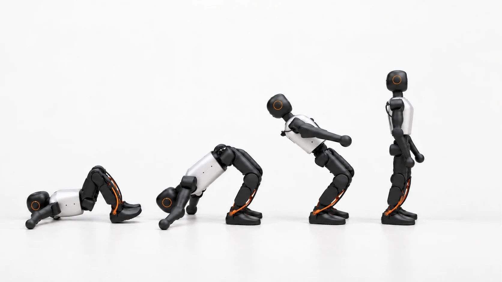 Four stages of a humanoid robot rising from the floor to stand upright